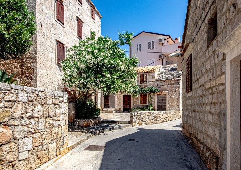 Komiza Vis street with blue sky and old buildings